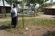 Community health worker Loice Ochieng stands over the grave of Mary Olouch, who died at 25 after a botched abortion procedure done without the help of healthcare professionals, in Karabok, Kenya, July 20, 2025.