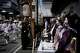 A geiko, a regional word for geisha, and a maiko watch festivalgoers pass by during one of the main parades of Shinto's Gion Matsuri festival in Kyoto, western Japan, Friday, July 17, 2026.