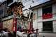 A festival float passes by maikos and geikos watching one of the main parades of Shinto's Gion Matsuri festival in Kyoto, western Japan, Friday, July 17, 2026.