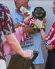 A woman holds a fan in front of a bottle-fed baby at the Great American State Fair, during an extreme heat wave, Friday, July 3, 2026, on the National Mall in Washington.