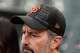 Giants fan Barry Cowan wears a hat with the names of Giants players and officials with rainbow colored lines through them in reaction to players recently writing on Pride-themed hats during a baseball game between the Giants and the A’s on Wednesday, June 24, 2026, in San Francisco.