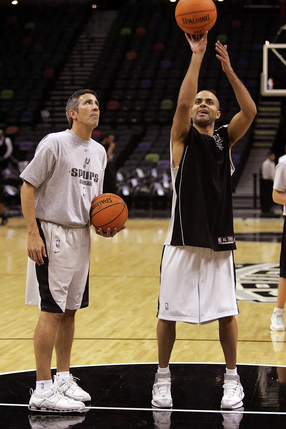 Spurs shooting coach Chip Engelland (left) works with guard Tony Parker prior to their pre-season game against the Philadelphia 76ers at the SBC Center on Thursday, October 27, 2005. (Kin Man Hui/staff)