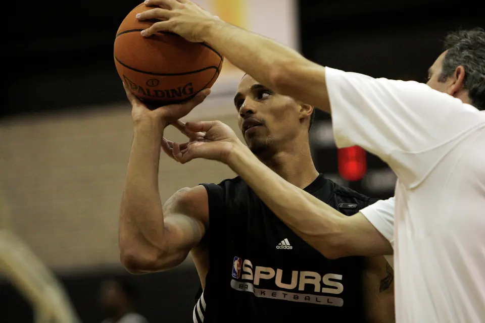SPURS -- San Antonio Spurs shooting coach Chip Engelland, right, offers free throw shooting advice to guard George Hill during practice on Thursday, Oct. 2, 2008. JERRY LARA/glara@express-news.net