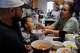 Lien Chang feeds her 2-year-old grandson Cairo Miu a bowl of rice next to his dad Jack Chang in her home on Monday, July 13, 2026, in San Francisco.
