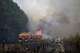 Firefighters tackle a blaze as wildfires rage near Le Las, outside Bordeaux, France, Monday, July 27, 2026.