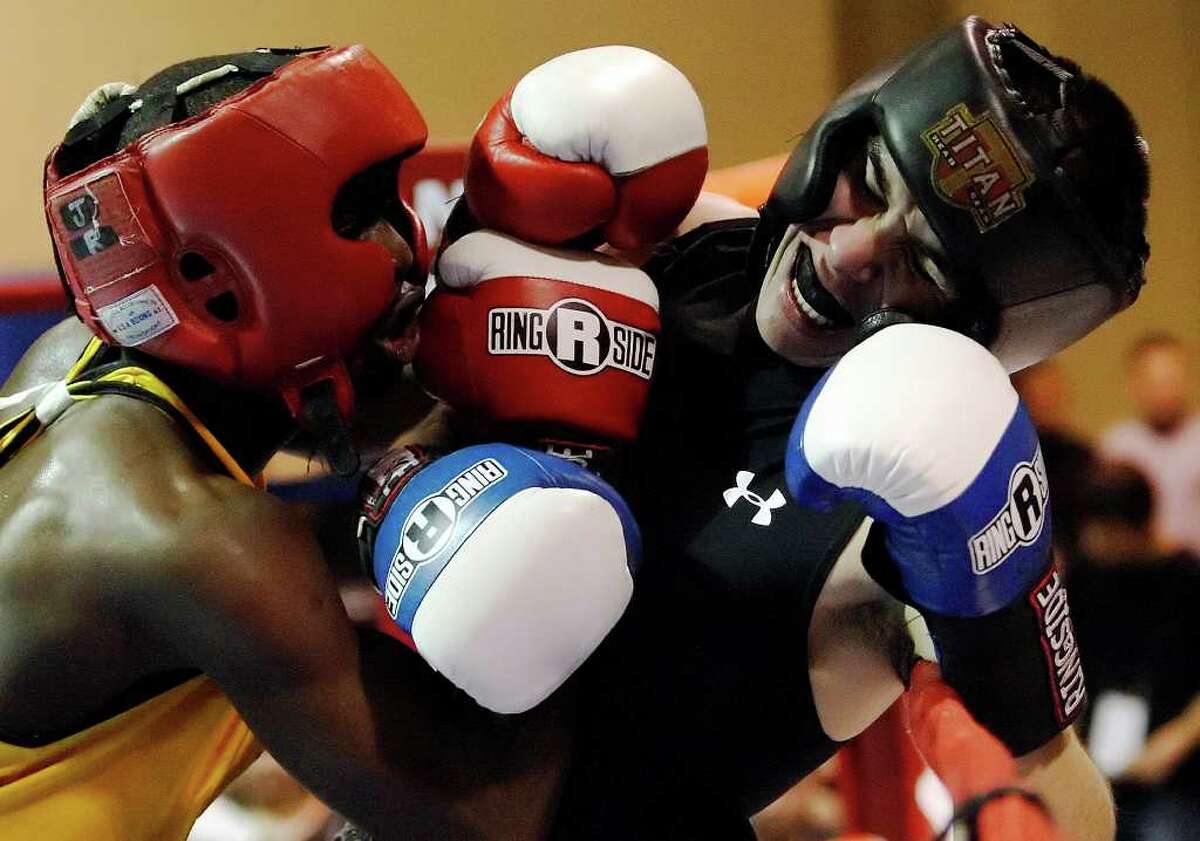 George Yeannue (left) pins Adrian Olivares of Ramos Boxing Team to the ropes during their novice lightweight bout at the San Antonio Regional Golden Gloves at Woodlawn Gym on Friday, Feb. 26, 2010. Yeannue won the fight.