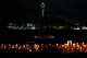 With a backdrop of the Space Needle, candles are seen lighted during the vigil for victims the day after a shooting at Seattle Center during the Bite of Seattle food festival, Monday, July 27, 2026, in Seattle.