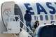 A man in restraints boards an Eastern Air Express plane at Dallas Love Field on Tuesday, July 28, 2026, in Dallas.