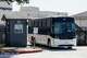A bus exits through a gate after dropping off and picking up people in restraints at Dallas Love Field on Tuesday, July 28, 2026, in Dallas.