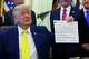 FILE - President Donald Trump holds up an image taken from his Truth Social account at an event about coal, Thursday, June 4, 2026, in the Oval Office of the White House in Washington.