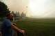 Andrew Rowley watches Old Trails Fire from Dwight Merkel Sports Complex after evacuating, Saturday, Aug. 1, 2026, in Spokane, Wash.
