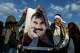 FILE - Youngsters hold a photograph of Abdullah Ocalan, the jailed leader of the militant Kurdish group, or PKK, in Diyarbakir, Turkey, Feb. 27, 2025.