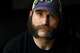 Joe Shearer, who was diagnosed with traumatic brain injuries from fighting in Iraq, poses for a portrait in his home in Colorado Springs, Colo., Wednesday, Aug. 5, 2026.