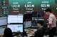 Currency traders watch monitors near a screen showing the Korea Composite Stock Price Index (KOSPI) and the foreign exchange rate between U.S. dollar and South Korean won at the foreign exchange dealing room of the Hana Bank headquarters in Seoul, South Korea, Monday, Aug. 10, 2026.