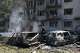 Rescue workers try to put out a fire of a residential building and cars burning after a Russian air guided bomb strike in Zaporizhzhia, Ukraine, Monday, Aug. 10, 2026.