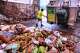 Paul Milonopolous rinses out the dump box after offloading fresh organic matter, which included biodegradable cups, cutlery and bin liners that were mixed in with food scraps and lobster shells, that will be used to make compost at Black Earth Compost, Monday, Aug. 3, 2026, in Manchester-by-the-Sea, Mass.