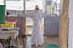 A health worker waits to be sprayed with disinfectant at the treatment centre in Bunia General Hospital in Ituri, eastern Congo, Tuesday, Aug. 11, 2026.