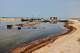 Oil residue lines the shore near fishing boats on Qeshm Island, Iran, Thursday, Aug. 13, 2026, amid ongoing wartime attacks on vessels and infrastructure in and around the Strait of Hormuz, though the spill's source has not been independently determined.(Amirhosein Khorgooi/ISNA via AP)