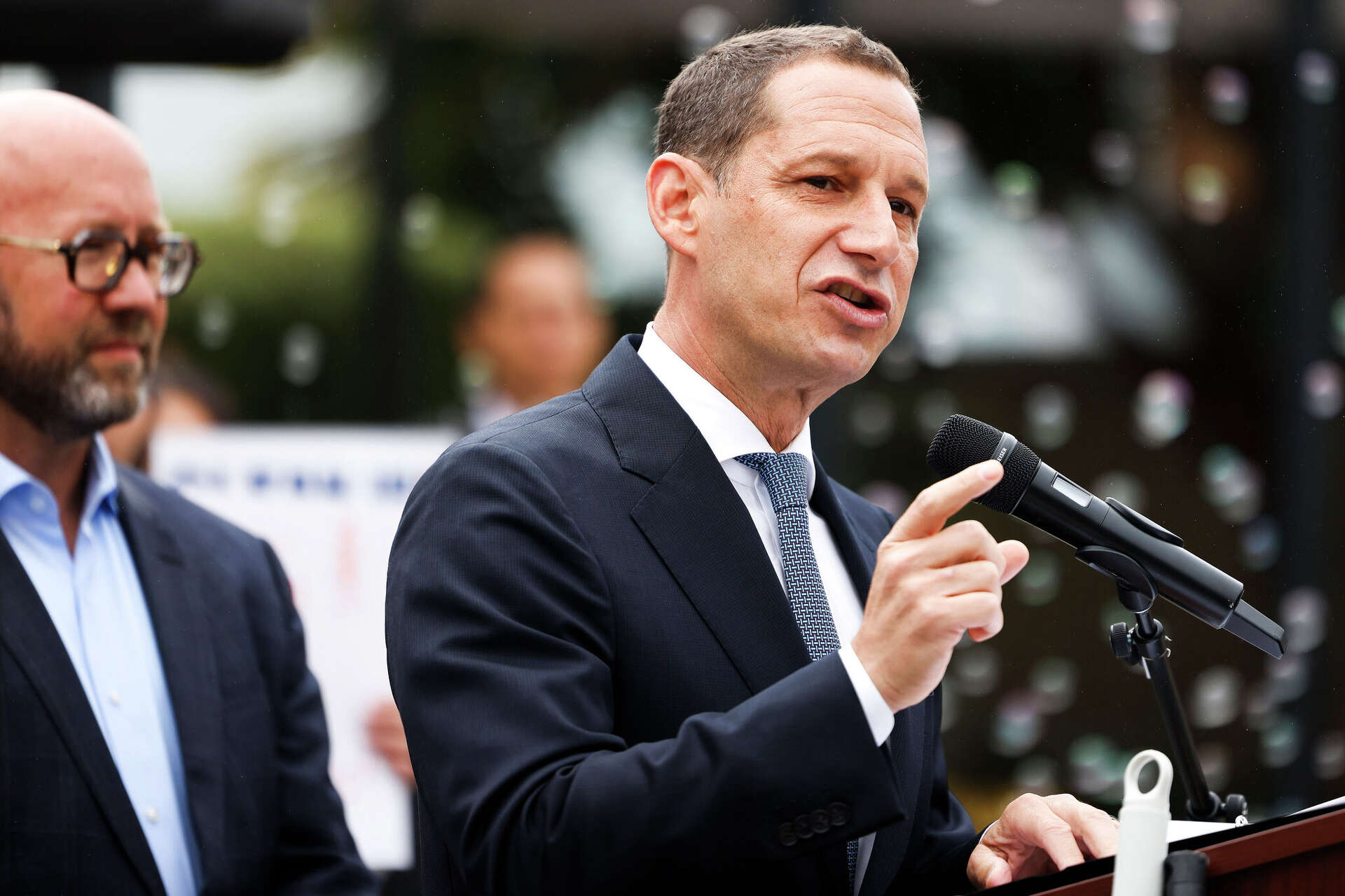 Standing alongside Board of Supervisors President Rafael Mandelman, San Francisco Mayor Daniel Lurie speaks during a July 29 news conference to promote three ba