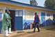 Gédéon Banga Ngbape, right, an Ebola surveillance officer, arrives at his office in Nizi, Ituri province, eastern Congo, Friday, Aug. 14, 2026.