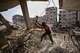 Palestinians remove iron from the rubble of buildings destroyed by Israeli airstrikes during the war with Hamas, repair and recycle it for construction, building tents or selling it, in Gaza City, Sunday, Aug. 16, 2026.