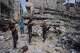 Palestinians remove iron from the rubble of buildings destroyed by Israeli airstrikes during the war with Hamas, repair and recycle it for construction, building tents or selling it, in Gaza City, Sunday, Aug. 16, 2026.