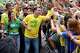 Opposition presidential candidate Flavio Bolsonaro and his wife, Fernanda Bolsonaro, greet supporters as they arrive for a presidential election campaign rally in Rio de Janeiro, Brazil, Sunday, Aug. 16, 2026.