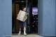 FILE - A man carrying a package leaves a pickup point for online retailer Wildberries in Moscow on Wednesday, July 22, 2026.