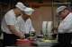 Chefs prepare dishes inside a kitchen of Fangshan Restaurant in Beijing on July 23, 2026.