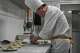 Chef Zhou Tong makes the minced pork pancake at Fangshan Restaurant inside Beihai Park in Beijing on July 23, 2026.