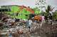 A backhoe clears earthquake debris in Quibdo, Colombia, Monday, Aug. 17, 2026.