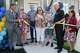 Delores Green cuts the ribbon to her new home alongside her husband Jerry Green (center right) and local officials during an event, Monday, Aug. 17, 2026, in Farmers Branch.