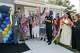 Delores Green (center left) reacts after cutting the ribbon to her new home alongside her husband Jerry Green (center right) and local officials during an event, Monday, Aug. 17, 2026, in Farmers Branch.