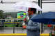 Fans use an umbrella to keep out of the rain near Volunteer Stadium during the Little League World Series on Thursday, Aug. 20, 2026 in South Williamsport, Pennsylvania.