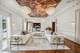 Decadent, muraled ceilings and ornate chandeliers are visible throughout the home.