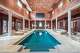 The indoor pool is set beneath an arched ceiling with star-like lights.
