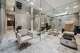 A pedicure-style chair is surrounded by mirrored walls.