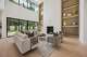 The fireplace is framed by a floor-to-ceiling fluted surround and built-in wood shelving.