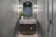 A floating, marble-looking vanity adds a unique touch to this bathroom.