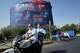 Motorcyclists pass a billboard depicting U.S. President Donald Trump underwater amid explosions, with the words "Great Victory! Strait of Hormuz," in Tehran, Iran, Monday, Aug. 24, 2026.