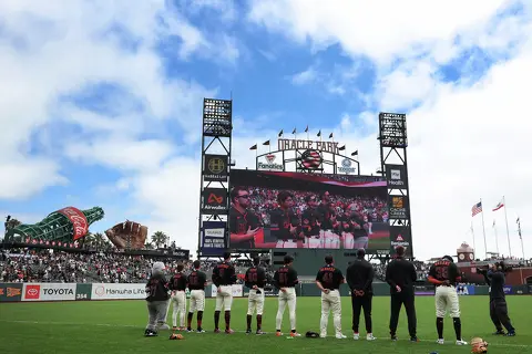 FILE: San Francisco Giants players stand for the national anthem before the game against the Colorado Rockies at Oracle Park in San Francisco on Aug. 15, 2026.