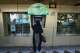 A woman uses an ATM in downtown Tehran, Iran, Monday, Aug. 24, 2026.