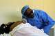 Male midwife Sehloho Ntlhane leans over a pregnant patient while using a Pinard horn to listen to the baby's heartbeat during a prenatal examination at Mpharane Health Centre in Mohale's Hoek district, Lesotho, Friday, July 10, 2026.