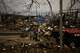 Destroyed vehicles and debris are scattered the day after a Russian attack struck a warehouse, followed by an explosion, in the village of Myla, outskirts of Kyiv, Sunday, Aug. 30, 2026.