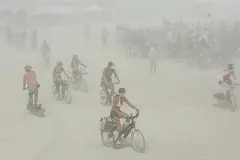 FILE: Burning Man festival participants endure a dust storm on the playa within the Black Rock Desert in Gerlach, Nev.