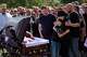 Relatives mourn Taras Didych, head of the Dmytrivska community in Kyiv region, who was killed while going to help local residents following a Russian drone attack during his funeral in Myla, on the outskirts of Kyiv, Monday, Aug. 31, 2026.
