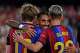 Barcelona's Anthony Gordon celebrates with his teammate Barcelona's Raphinha, center, and Barcelona's Dani Olmo, right, after Rayo's Florian Lejeune scores an own goal during a Spanish La Liga soccer match between Barcelona and Rayo Vallecano in Barcelona, Spain, Monday, Aug. 31, 2026.