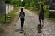 Children drag toys made from cardboard boxes as they walk in Minas, in Cuba's Havana province, Monday, Aug. 31, 2026.