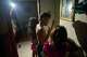 Yurima Izaguirre, left, shines her cell phone flashlight during a blackout as her children brush their teeth and get ready for their first day back to school in Minas, Cuba's Havana province, Tuesday, Sept. 1, 2026.