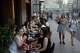FILE - People sit at a sidewalk cafe on a hot summer day in Moscow, Friday, July 3, 2026.
